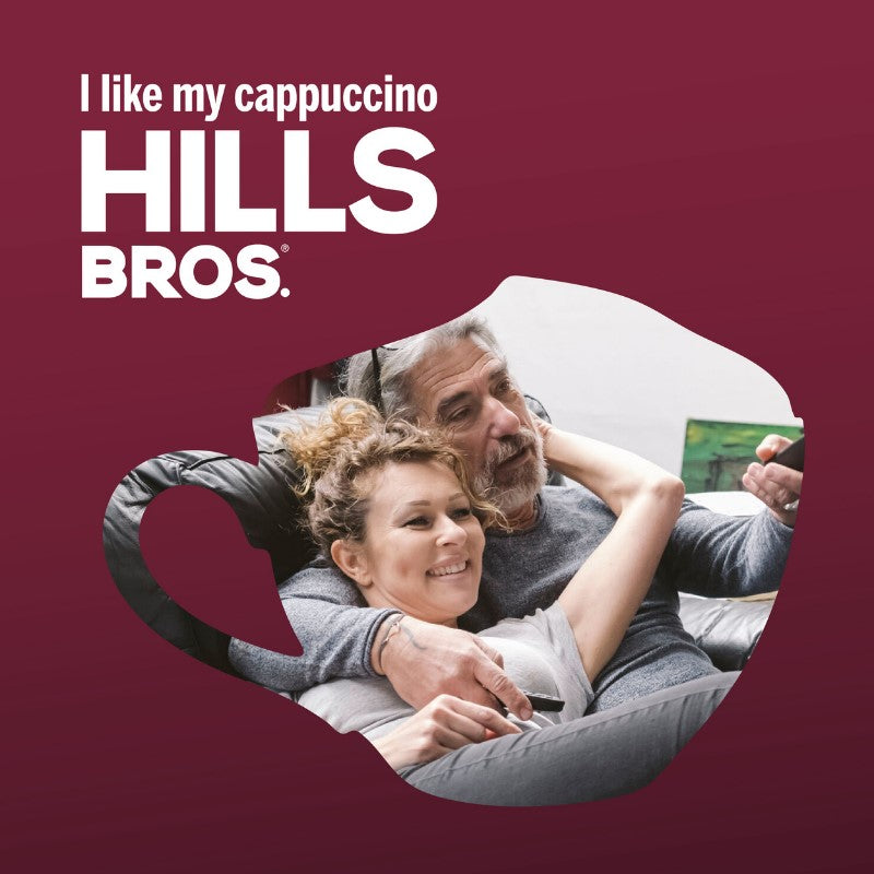 An elderly man and a young woman smiling and cuddling inside a coffee cup-shaped frame with a Hills Bros. Cappuccino sugar cookie ad slogan.