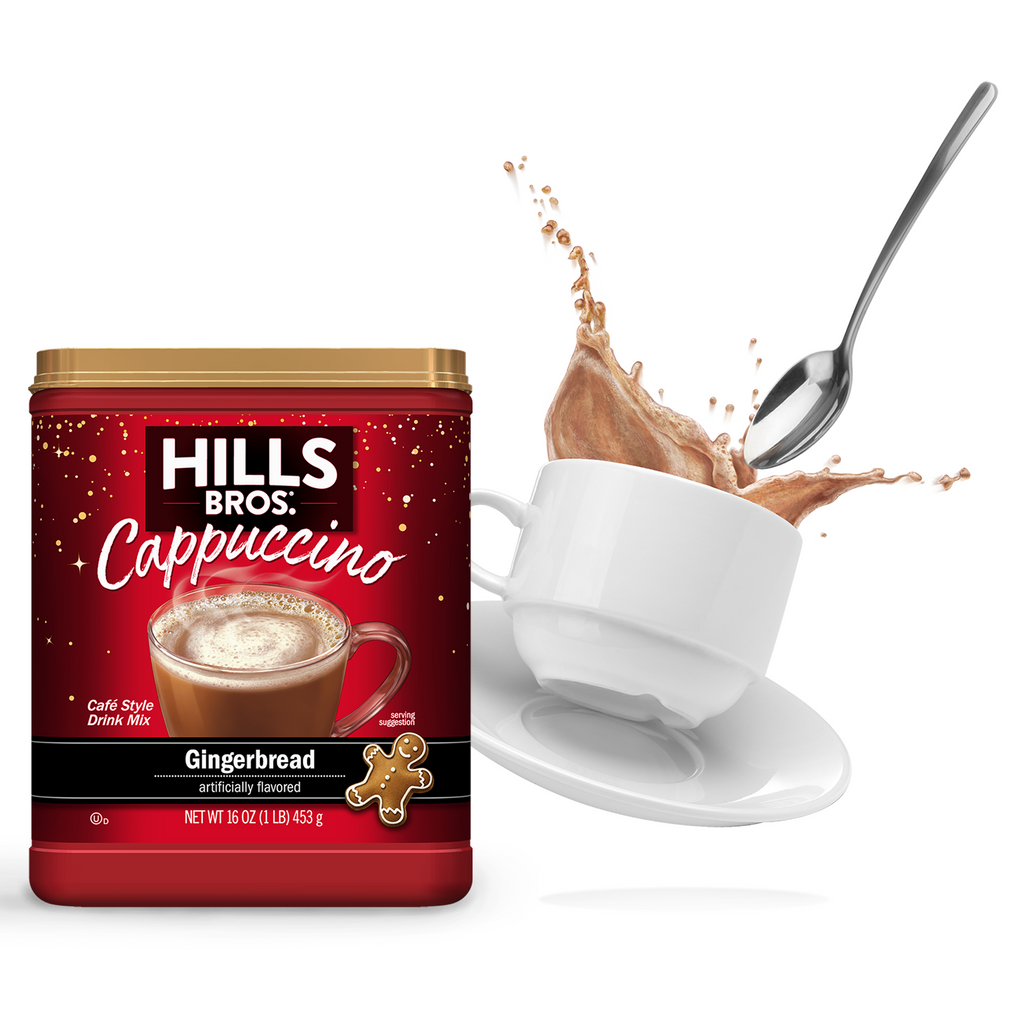 A container of Hills Bros. Gingerbread Cappuccino Mix next to a cup with a spoon and a splash of Hills Bros. Instant Cappuccino.