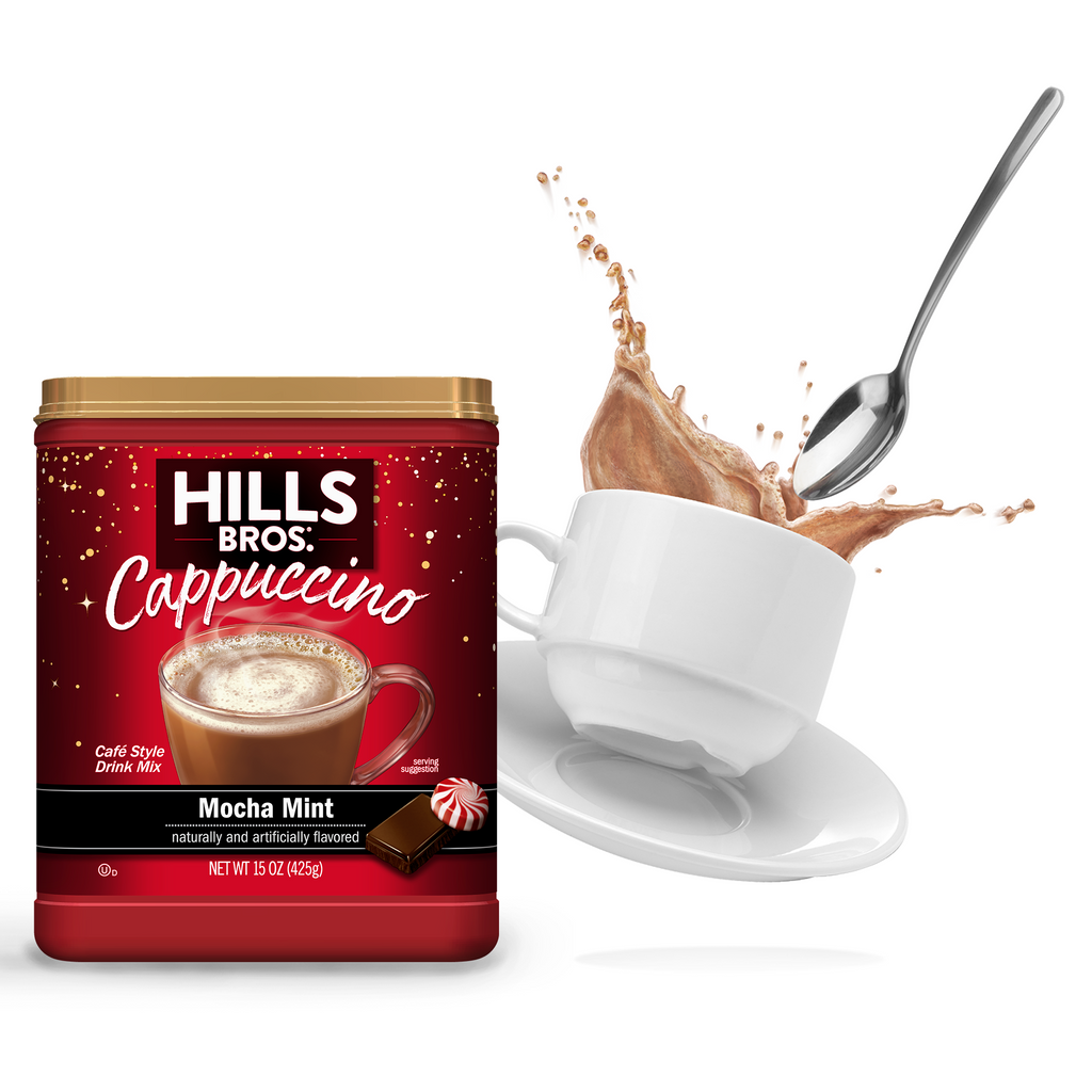 A jar of Hills Bros. Cappuccino Mocha Mint flavored Instant Cappuccino Mix next to a white cup with cappuccino spilling over, and a floating spoon.