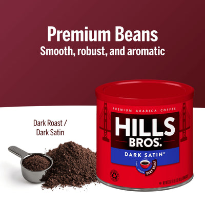 A red can of Hills Bros. Coffee Dark Satin Dark Roast Premium Arabica ground coffee sits by a scoop and coffee grounds. Text reads: "Smooth, robust, aromatic dark roast made from premium Arabica beans.