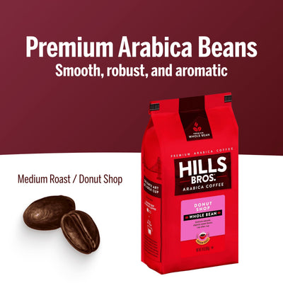 A red bag of Hills Bros. Coffee Donut Shop Medium Roast Whole Bean Premium Arabica sits with two coffee beans on a white and maroon background.