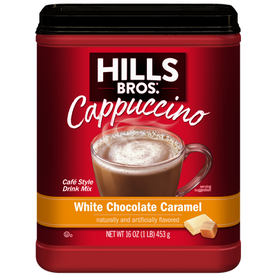 A 16 oz container of Hills Bros. Cappuccino White Chocolate Caramel Instant Cappuccino Mix featuring a cappuccino in a clear mug on the front.