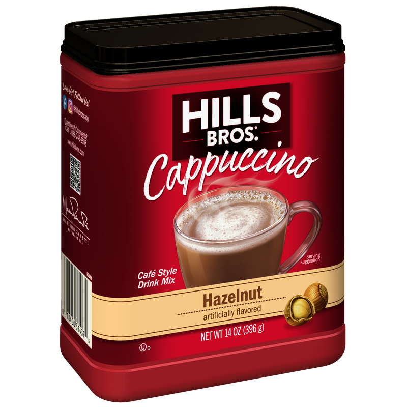 A 14 oz red container of Hills Bros. Cappuccino Hazelnut - Instant Cappuccino Mix, featuring an image of a cappuccino and two hazelnuts on the front. This instant cappuccino mix from Hills Bros. Cappuccino is perfect for anyone who enjoys the rich, nutty flavor of classic hazelnut cappuccinos.