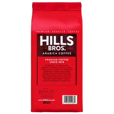 A red bag of Hills Bros. Coffee 100% Colombian Medium Roast Whole Bean, made from premium Arabica coffee beans, features white text and a description of the brand’s history and commitment to quality coffee.