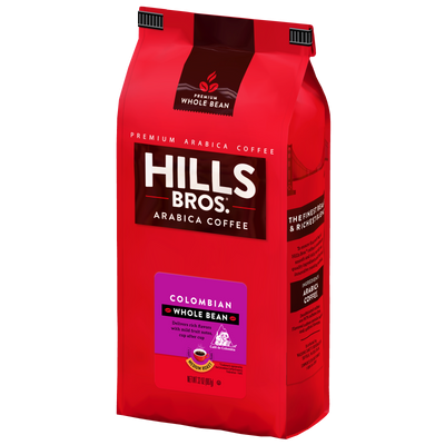 A red bag of Hills Bros. Coffee 100% Colombian Medium Roast Whole Bean Premium Arabica stands upright, showcasing the branding and product details on its front and side panels.