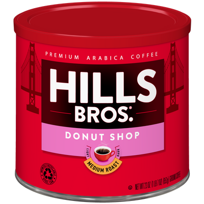 A 23 oz red canister of Hills Bros. Coffee Donut Shop Medium Roast Ground, made from premium Arabica beans, with a label displaying a Golden Gate Bridge illustration and a small coffee cup graphic.
