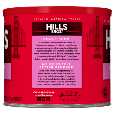 A red can of Hills Bros. Coffee Donut Shop Medium Roast Ground, made from premium Arabica beans, showcases information about the Donut Shop blend and highlights the recyclable packaging printed on the side.