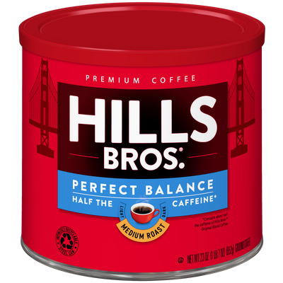 A red can of Hills Bros. Coffee Perfect Balance Medium Roast Ground, featuring “half the caffeine” labeling and Golden Gate Bridge graphics on both sides, crafted from premium coffee beans for a rich and balanced flavor.