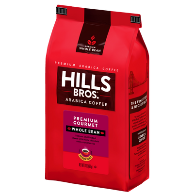 A red 2 lb bag of Hills Bros. Coffee Premium Gourmet Medium Roast Whole Bean, made with premium Arabica beans, featuring product information and branding on gluten free packaging.