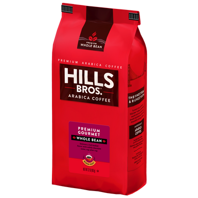 A red bag of Hills Bros. Coffee’s “Premium Gourmet - Medium Roast - Whole Bean” features prominent branding and detailed product information on the packaging. Crafted from premium Arabica coffee beans and naturally gluten free, this blend promises a high-quality coffee experience in every cup.